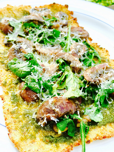 Gluten-free, Dairy-free Cauliflower Crust topped with pesto and mushrooms. Great lighter dinner for the warmer weather!