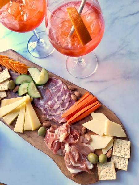 Aperitivo time! An Aperol Spritz and a charcuterie are the perfect happy hour pairing.